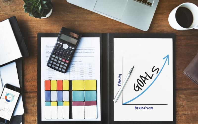 Inspection report, calculator and planning notes on a desk