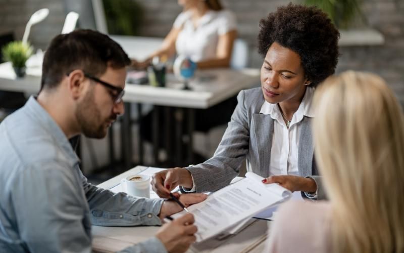 Reinsurance specialist reviewing a placement with clients